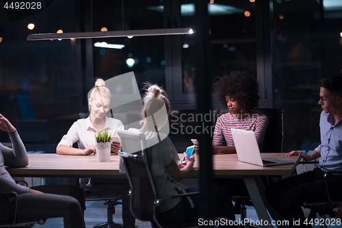 Image of Multiethnic startup business team in night office