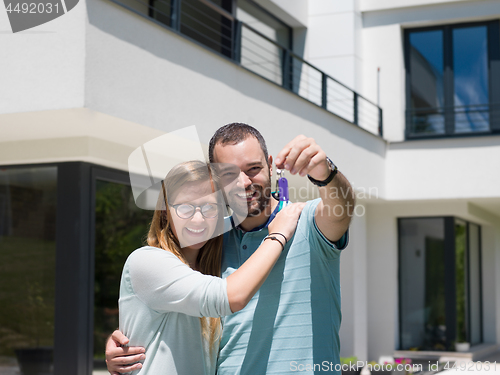 Image of couple hugging in front of  new luxury home