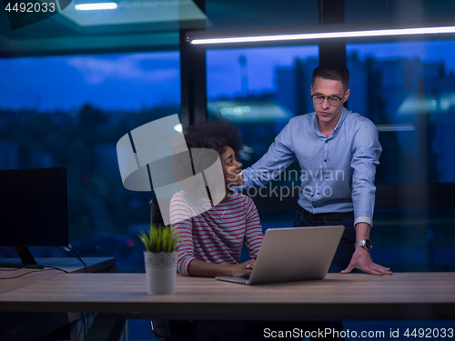 Image of Multiethnic startup business team in night office