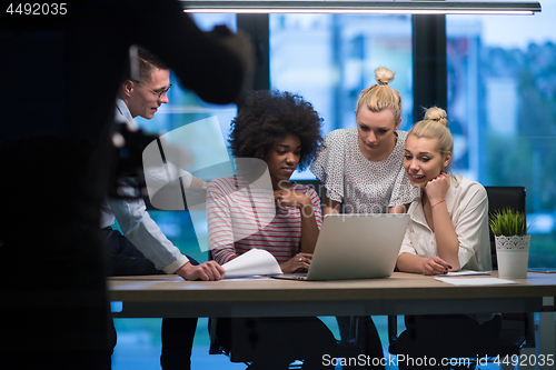 Image of Multiethnic startup business team in night office