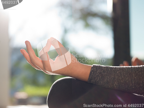 Image of young woman doing morning yoga exercises