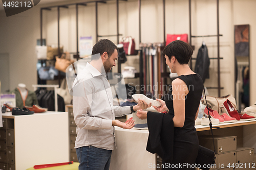 Image of couple chooses shoes At Shoe Store