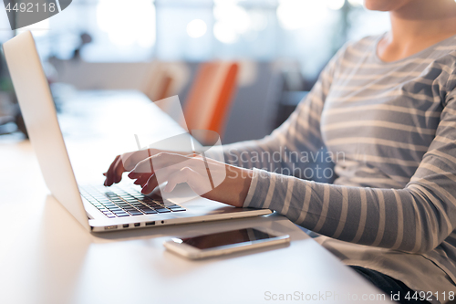 Image of businesswoman using a laptop in startup office