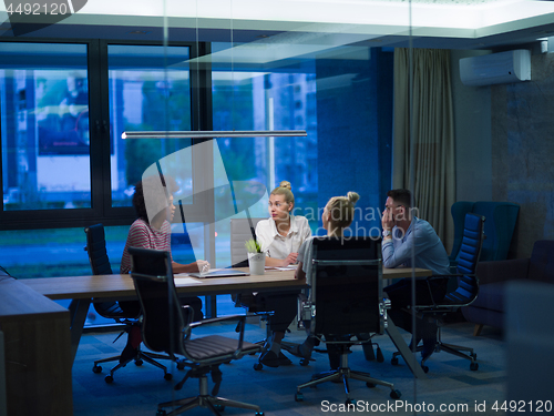 Image of Multiethnic startup business team in night office