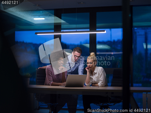 Image of Multiethnic startup business team in night office