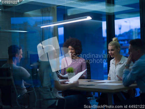 Image of Multiethnic startup business team in night office