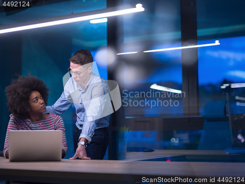 Image of Multiethnic startup business team in night office