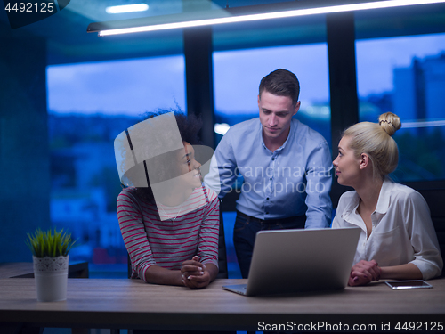 Image of Multiethnic startup business team in night office