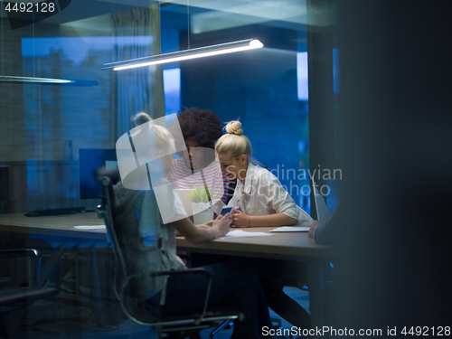 Image of Multiethnic startup business team in night office