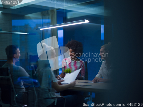 Image of Multiethnic startup business team in night office