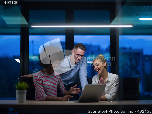 Image of Multiethnic startup business team in night office