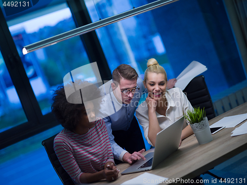 Image of Multiethnic startup business team in night office