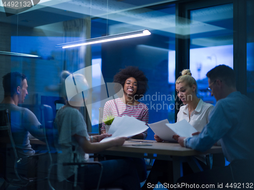 Image of Multiethnic startup business team in night office