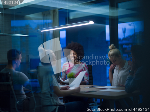 Image of Multiethnic startup business team in night office