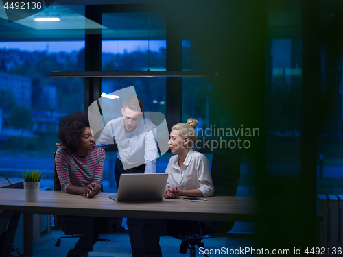 Image of Multiethnic startup business team in night office