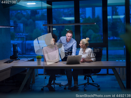 Image of Multiethnic startup business team in night office