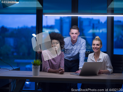 Image of Multiethnic startup business team in night office
