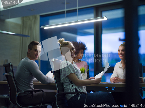 Image of Multiethnic startup business team in night office