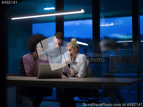 Image of Multiethnic startup business team in night office