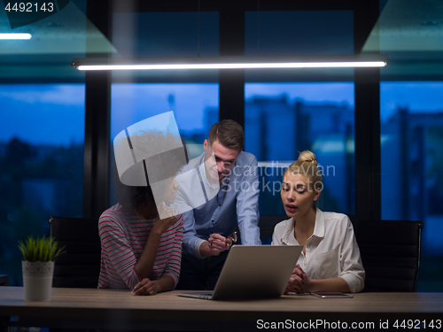 Image of Multiethnic startup business team in night office