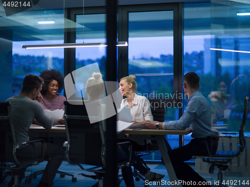 Image of Multiethnic startup business team in night office