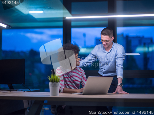 Image of Multiethnic startup business team in night office