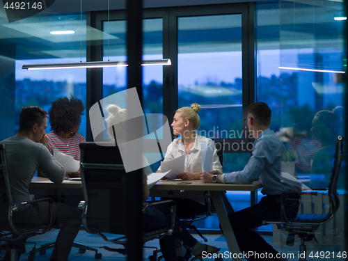 Image of Multiethnic startup business team in night office