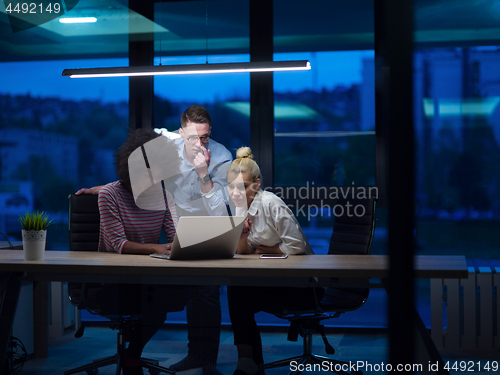 Image of Multiethnic startup business team in night office