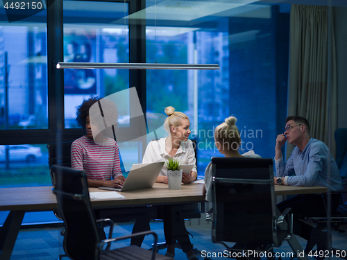 Image of Multiethnic startup business team in night office