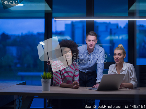 Image of Multiethnic startup business team in night office