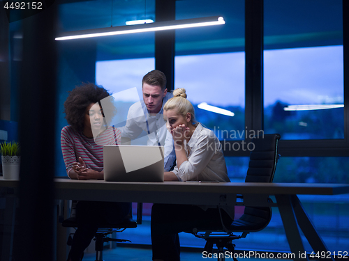 Image of Multiethnic startup business team in night office