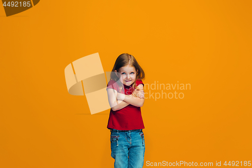 Image of Beautiful teen girl looking suprised and bewildered isolated on orange