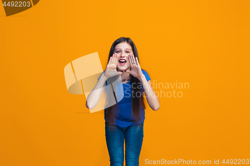 Image of Isolated on yellow young casual teen girl shouting at studio