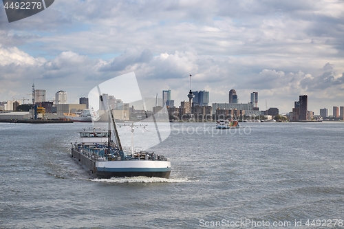 Image of Ship carrying containers through rotterdam