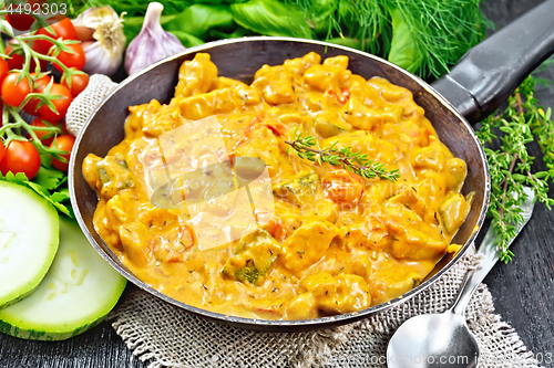 Image of Goulash with tomato and zucchini in pan on burlap