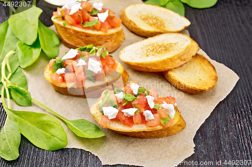 Image of Bruschetta with tomato and cheese on board