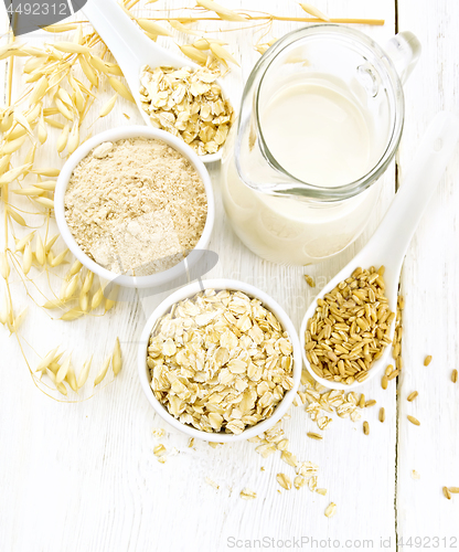 Image of Oat flakes with flour and milk on board top