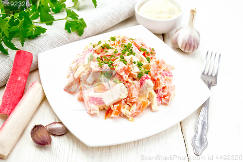 Image of Salad of surimi and tomatoes with mayonnaise on light board