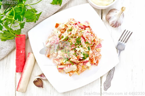 Image of Salad of surimi and tomatoes with mayonnaise on light board top