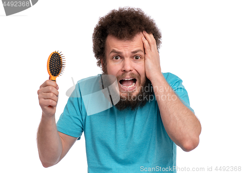 Image of Crazy bearded man with hairbrush