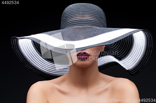 Image of Beautiful girl in large hat