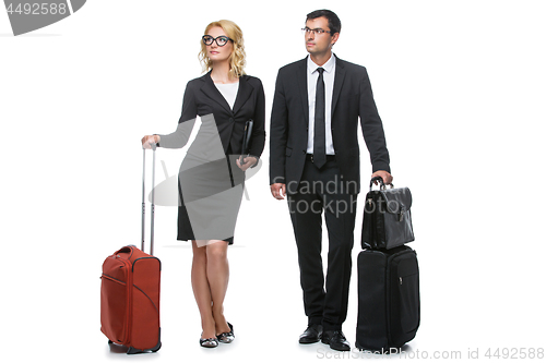 Image of Businessman and business woman with travel cases