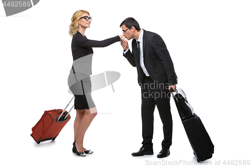 Image of Businessman and business woman with travel cases