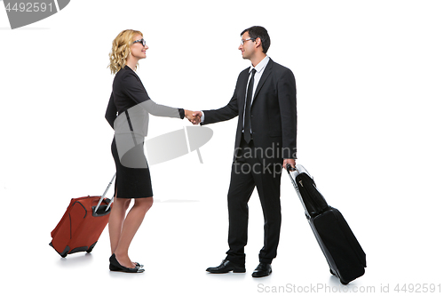 Image of Businessman and business woman with travel cases