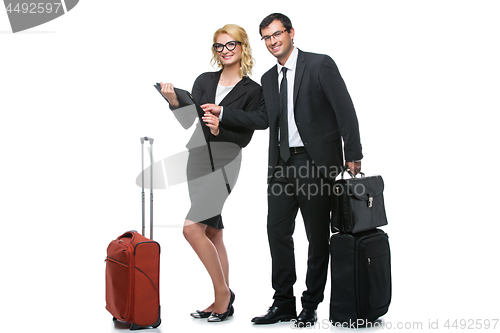 Image of Businessman and business woman with travel cases