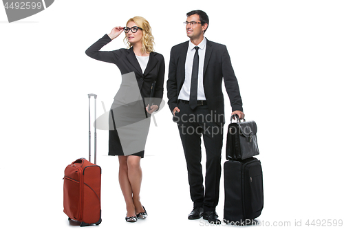 Image of Businessman and business woman with travel cases