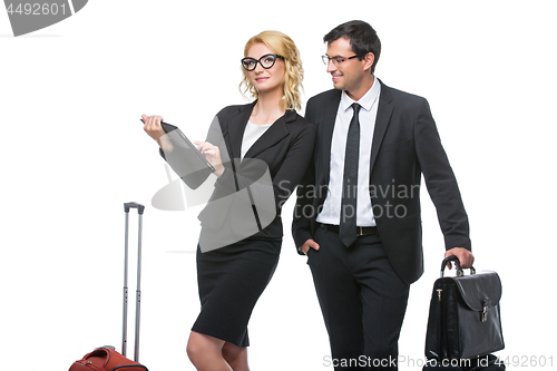 Image of Businessman and business woman with travel cases