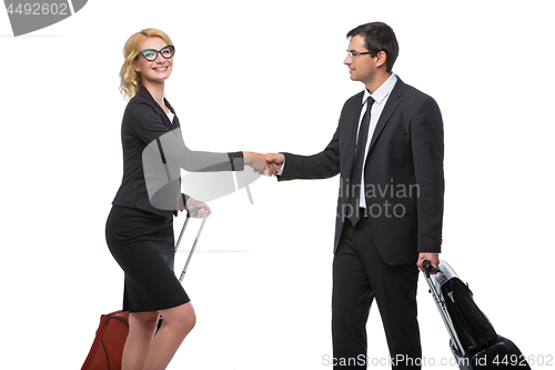 Image of Businessman and business woman with travel cases