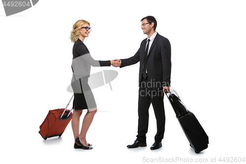 Image of Businessman and business woman with travel cases