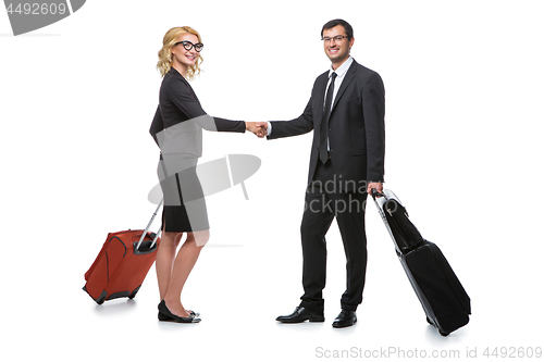 Image of Businessman and business woman with travel cases